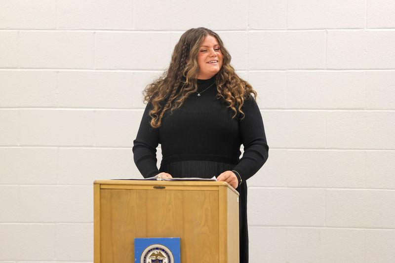 Brandi speaking at a podium